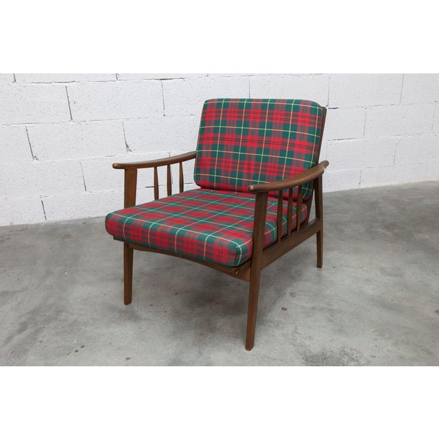 Scandinavian teak armchair from the 1960s, with a tartan fabric seat and back. It is sturdy and easy to disassemble....