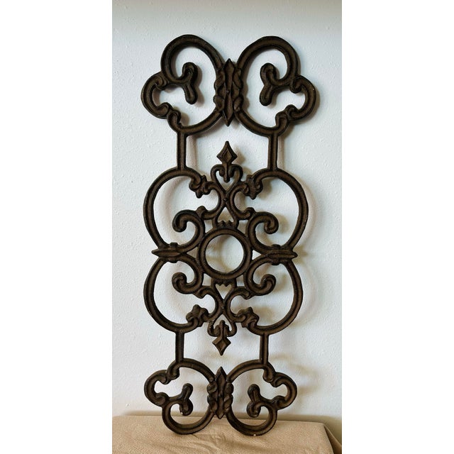 Beautiful, intricate scroll work made of solid cast iron with a powdered cocoa paint. Perfect wall accent piece for any...