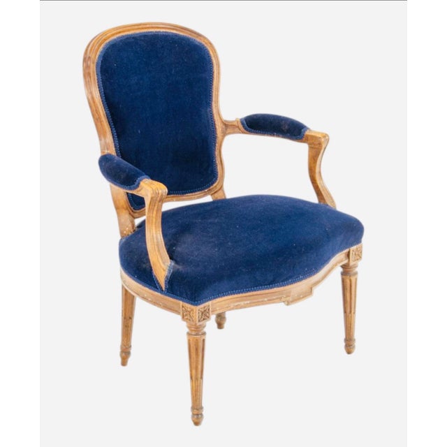 Antique French Louis XVI Style Blue Velvet Armchair, Circa 1900 A wonderfully decorative French armchair—the deep...