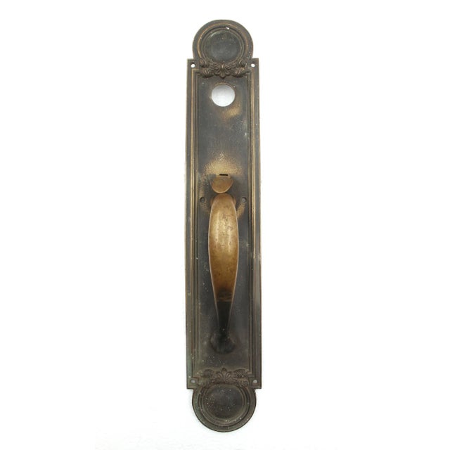 Art Deco style entry door pull made of bronze with a thumb latch and lock insert. It is made by Penn Hardware. The...
