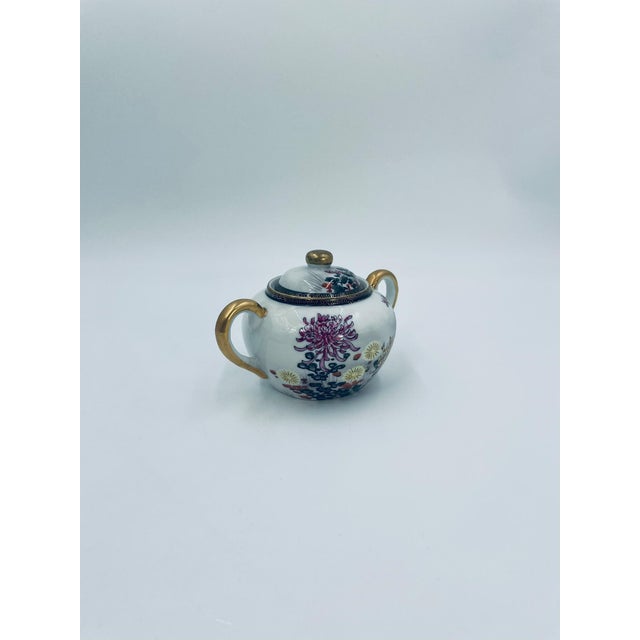 Japanese sugar bowl in the Kutania style, made of high-quality white porcelain. The bowl has a matching lid and two gold...