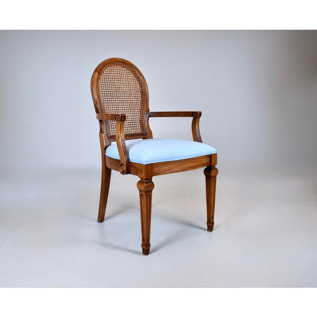 A lovely Louis XVI style open armchair with caned back, exquisite carved detailing, tapered legs and new seat in sky blue...