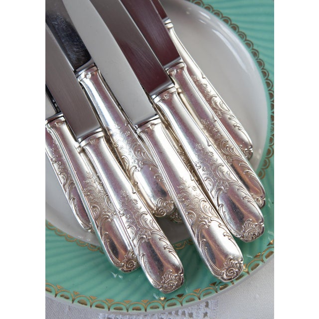 Set of 12 dessert or entremets knives with silver-plated metal handles decorated in Louis XV / Rococo style and stainless...