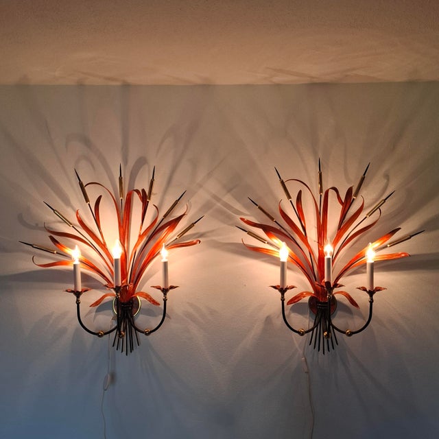 En exceptionally rare and sculptural pair of wall sconces from the Mid-Century Modern period, in the striking Hollywood...