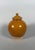 A covered terracotta vase with an amber glaze, Tang Dynasty (618-907). The upper part, covered with an amber glaze,...