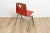 Model S22 by Galvanitas. The chair comes with a red wooden seating and backpiece on a grey coated metal frame. This piece...