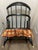 A charming mid-century Windsor-style comb-back armchair manufactured by the Rousseau Bros. Mfg. Co. Inc. of Gardner,...