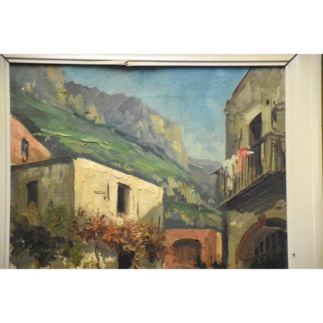 An old city view oil on canvas painting signed. 14.5” wide. 18.5” tall.