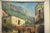 An old city view oil on canvas painting signed. 14.5” wide. 18.5” tall.