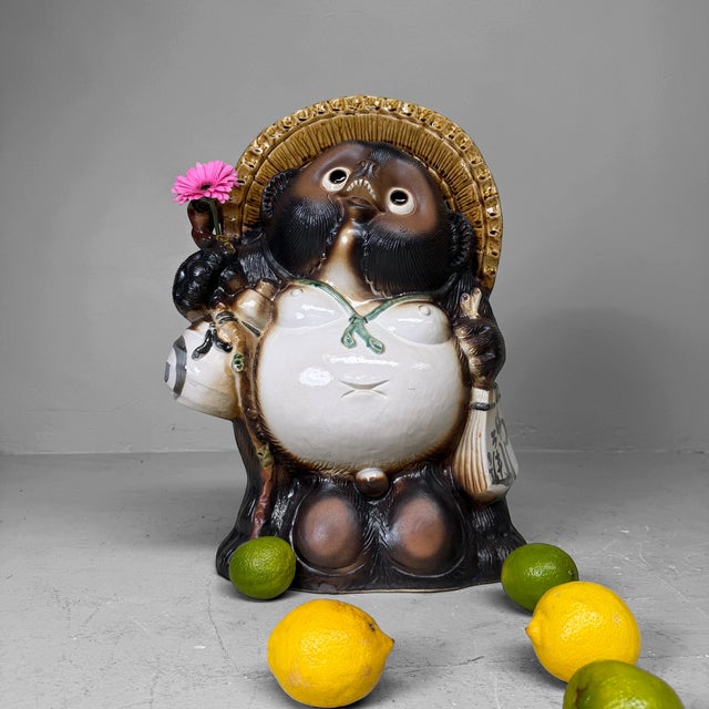 Large decorative Japanese tanuki statue, made of glazed ceramic and most likely dating from the 1960s–1970s. Dimensions:...