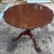 A finely crafted solid mahogany tilt-top table by Baker Furniture from their celebrated Historic Charleston Collection....