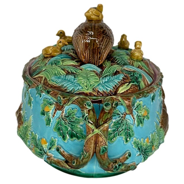 A George Jones Majolica Game Tureen, the base with relief molded rabbits among ferns and grasses on both sides, with oak...