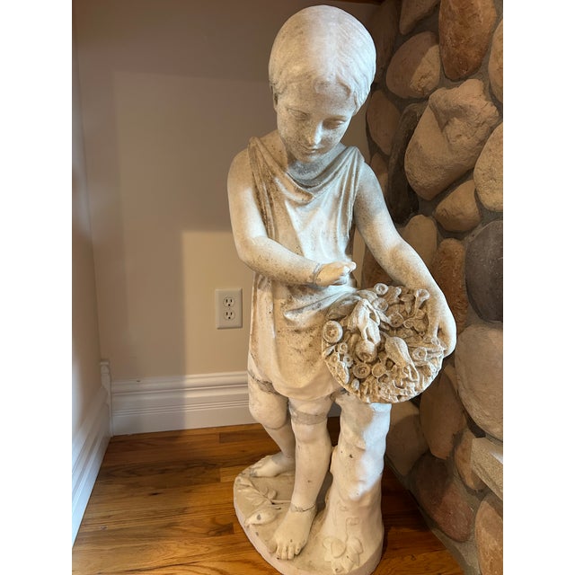 A CARVED MARBLE Emil Wolff young girl child with flower bouquet. This sculpture is from the 1800s. Probably 1850s Emil...