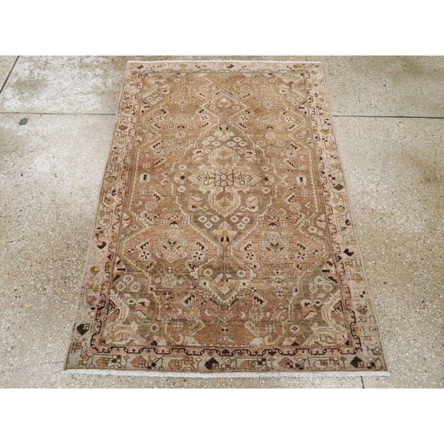 This early 20th century Persian Malayer rug, measuring 3' 1" x 4' 8", features a refined medallion-and-corner design...