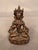 Striking vintage bronze statue of Buddha, featuring a seated figure with a traditional meditative posture and serene...