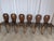 Vintage wooden dining chairs made in Yugoslavia, circa 1960s–1970s. The chairs feature a charming rustic folk design with...