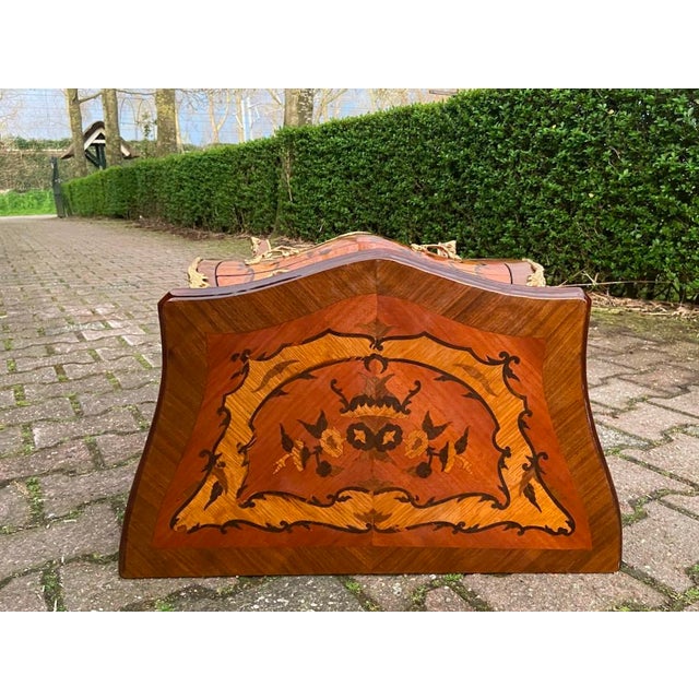 A refined vintage French Louis XVI style commode dating from the 1960s, beautifully crafted from rich mahogany with...