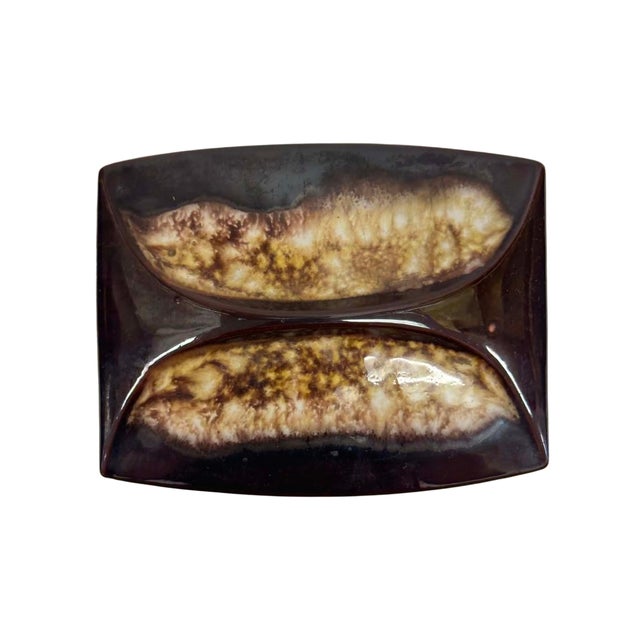 Distinctive vintage Japanese ceramic box featuring a deep brown glaze and a sculptural, abstract design across the fitted...