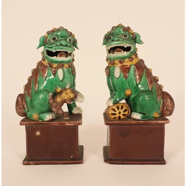 A good pair of 19th c. Chinese porcelain foo dogs in famille vert glaze. Each measures 7 1/2" tall x 4" wide. Good...