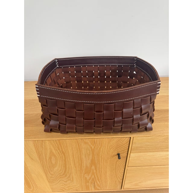 Contemporary woven basket by Arte & Cuoio, the renowned Italian maker known for luxury handcrafted leather goods. This...