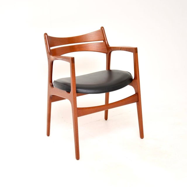 A stylish and incredibly well made Danish vintage teak carver desk chair / armchair by Erik Buch. This was made in Denmark...