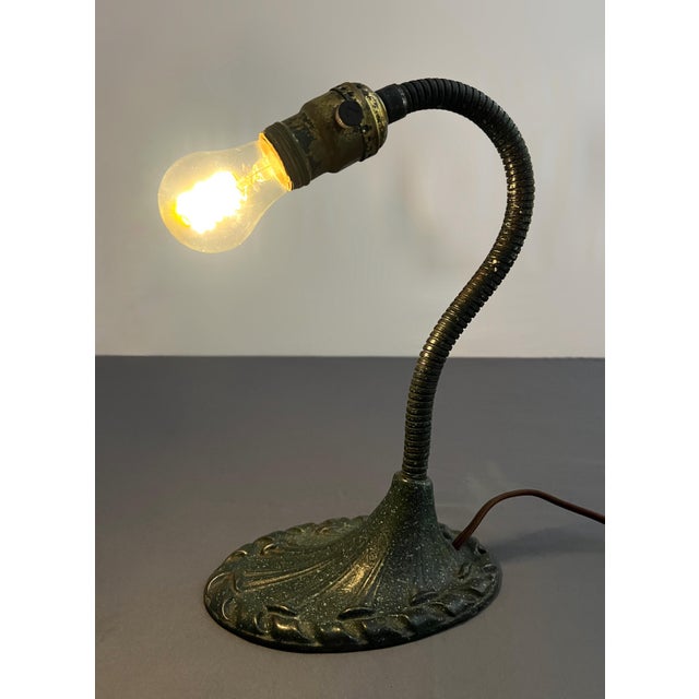 This vintage gooseneck desk lamp, produced by the renowned Aladdin Manufacturing Company of Muncie, Indiana, features a...