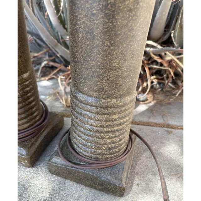 Striking vintage/retro table lamp pair featuring substantial cylindrical ceramic or stoneware bodies finished in a warm...