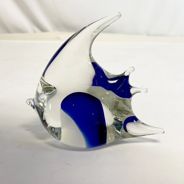 We have here a hand-blown glass Fish Paperweight Figural. It’s lovely with royal blue glass encased in the transparent...