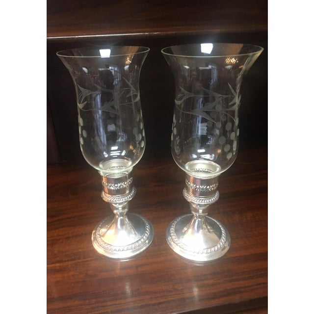 A lovely addition to any table. this classic American pair of sterling silver candlesticks feature decorative qadrooned...