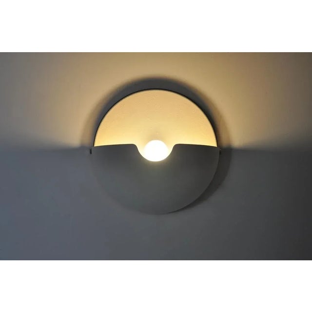 White plastic wall lamp Possibility of tilting up or down the projection of light. Mezzanotte model. Wear due to time and...