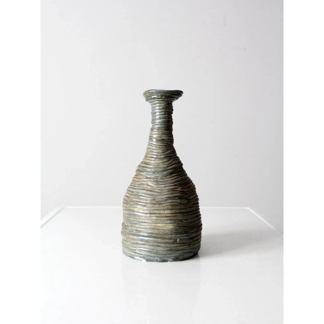 A vintage studio pottery vase, hand-crafted with a sculptural slab construction that spirals gracefully around the form....