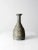 A vintage studio pottery vase, hand-crafted with a sculptural slab construction that spirals gracefully around the form....