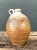 This vintage handcrafted pottery vessel showcases a classic rounded form that tapers to a narrow neck and finishes with a...