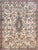 A beautiful early 20th century Persian Kirman rug with a large central floral medallion living in a field of even more...