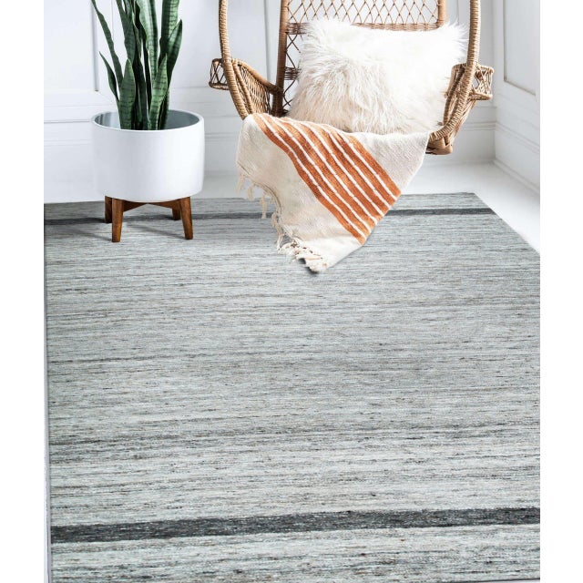 Lila Violet Light Gray Flatweave Wool Rug, Country of Origin: India. This exceptional piece exemplifies the minimalist...