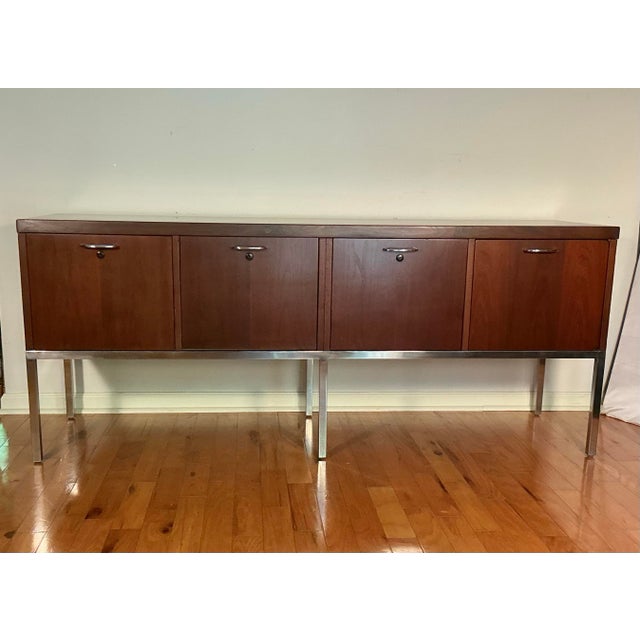 This is a Mid-Century Modern credenza, sideboard, or executive office cabinet, from 1960s or 1970s. Features wood veneer...