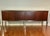 This is a Mid-Century Modern credenza, sideboard, or executive office cabinet, from 1960s or 1970s. Features wood veneer...