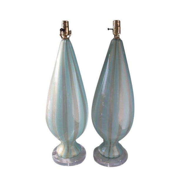 A Stunning pair of urn-shaped Murano glass lamps in crystal and turquoise stripe ("sticks") with 24k gold flecks. These...
