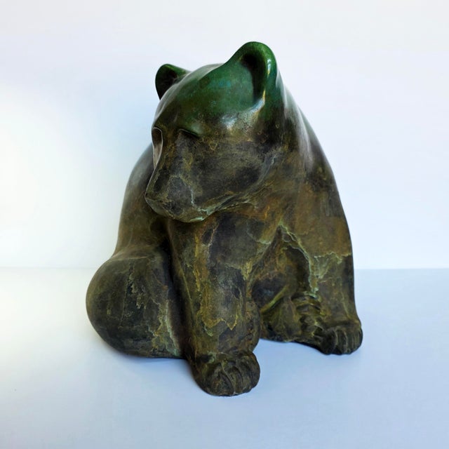 A large signed Tony Evans raku pottery bear sculpture from 1988, featuring a richly textured surface with green, bronze,...
