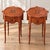 An elegant matching pair of vintage nightstands featuring floral marquetry, geometric parquetry and beautifully shaped...