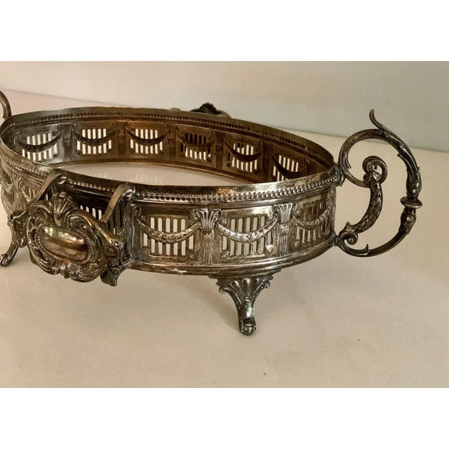 A wonderful and very detailed silver plate tray with wide gallery. Details include handles, and a rope / sash movement...
