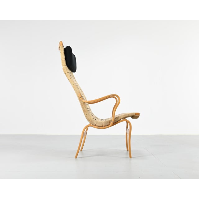 Eva armchair, designed by bruno mathsson for karl mathsson. Bent beechwood frame, seat and backrest in woven hemp webbing....
