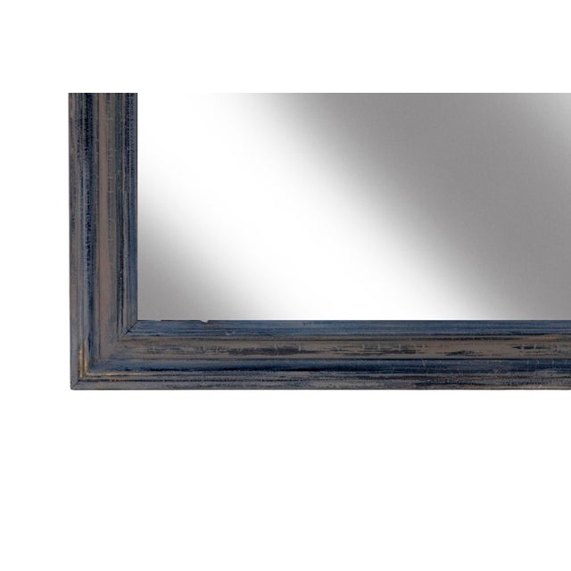 A wood framed mirror featuring a matte aged gray finish over brown stain which was applied over the mirrors original...