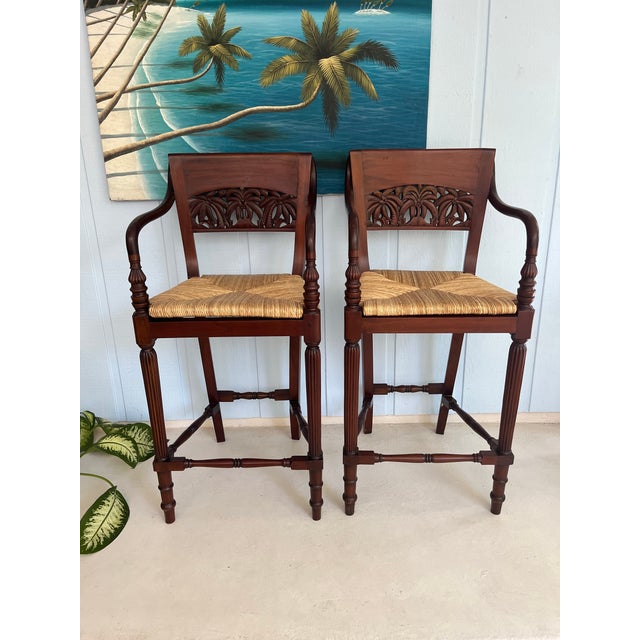 Features: -Solid wood and woven rush seat -Ornate hand carved back with palm trees motif -Elegant design on arms, legs and...
