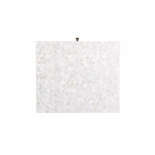 The Royal Bedside Table harmoniously exudes a perfect pairing of textures, with a mother of pearl overlay on the tabletop...