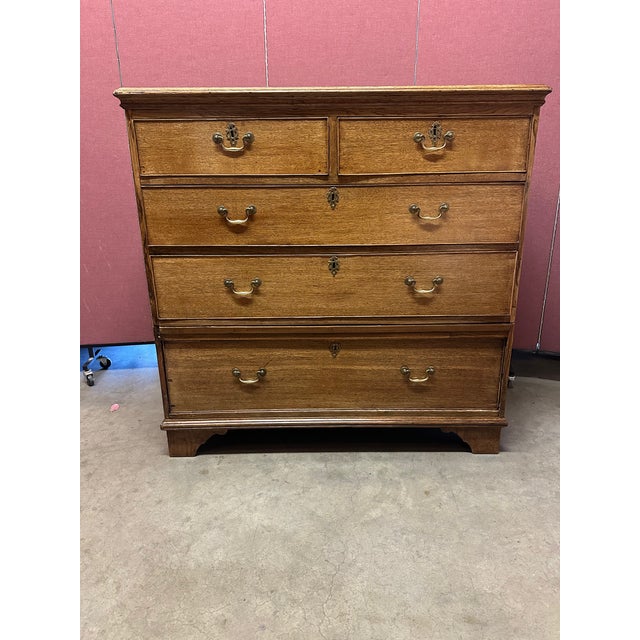 A handsome Georgian-style chest of drawers, distinguished by its timeless proportions and understated elegance. The piece...