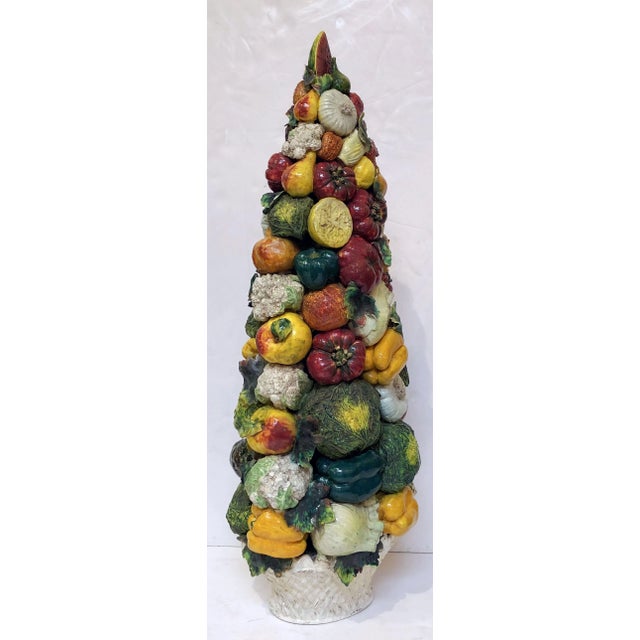 A fine Majolica vegetable tower or topiary, attributable to the ceramic artisans of Este, Italy, featuring a naturalistic...
