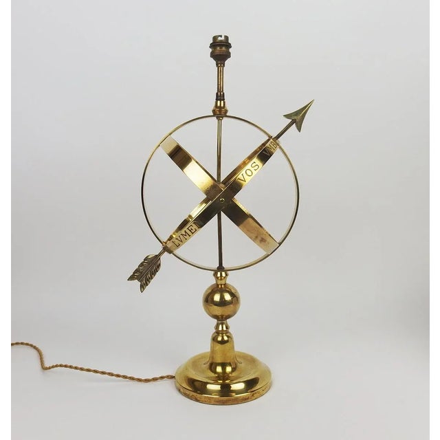 Brass table lamp representing an armillary sphere. France, circa 1960. Dimensions without lampshade: Height: 50cm, depth:...