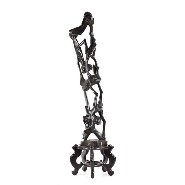 This carving specifically features Shetani, the Swahili word for "devil," which are expressions of Makonde mythology and...