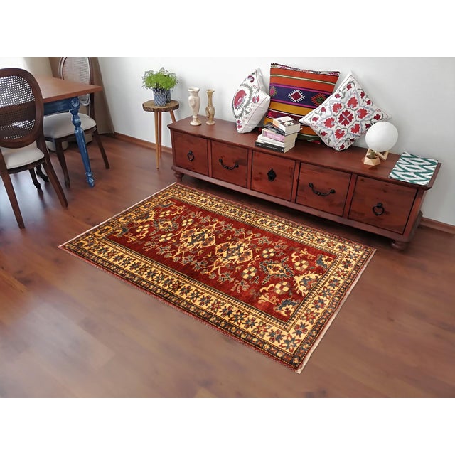 Enhance your home with this exquisite hand-knotted Super Kazak rug, crafted from fine hand-spun wool and dyed with all-...